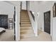 Well-lit carpeted stairway leading to upper levels with white walls and dark trim accents at 11941 Sand Dollar Cir, Indianapolis, IN 46256