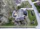 Overhead view showcasing the home, landscaped backyard with a deck, fire pit, and lush surroundings at 12065 Watermark Ct, Indianapolis, IN 46236