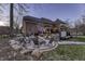 Cozy backyard with a stone fire pit, seating area, and a luxurious hot tub at 12065 Watermark Ct, Indianapolis, IN 46236