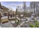 Serene backyard featuring a deck, hot tub, and fire pit area surrounded by lush landscaping and mature trees at 12065 Watermark Ct, Indianapolis, IN 46236