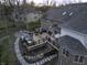 Elevated backyard view highlighting the deck, hot tub, fire pit, and meticulously landscaped grounds at 12065 Watermark Ct, Indianapolis, IN 46236
