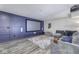 Finished basement with a home theater, paneled walls, projector, and large comfortable couch at 12065 Watermark Ct, Indianapolis, IN 46236