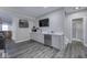 Basement bar area boasts a sink, microwave, dishwasher, white cabinets, a mounted TV, and decor at 12065 Watermark Ct, Indianapolis, IN 46236