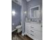 Stylish powder room with marble counters, hardwood floors, and modern fixtures at 12065 Watermark Ct, Indianapolis, IN 46236