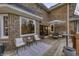 Wooden deck with outdoor seating, a small table, and an umbrella for shade at 12065 Watermark Ct, Indianapolis, IN 46236