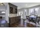 Inviting dining area features a custom wine rack, granite countertops, and sun-filled windows overlooking the outdoor patio at 12065 Watermark Ct, Indianapolis, IN 46236