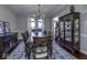 Elegant dining room boasts tray ceiling, a chandelier, a large cabinet, and a doorway view to front door and stairs at 12065 Watermark Ct, Indianapolis, IN 46236