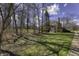View of the house showcasing the large lawn, mature trees, and establishing neighborhood at 12065 Watermark Ct, Indianapolis, IN 46236