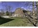 Exterior view of the home showcasing a spacious yard, multiple car garage, and attractive brickwork at 12065 Watermark Ct, Indianapolis, IN 46236