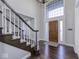 Grand foyer with hardwood floors, staircase and large window above the front door at 12065 Watermark Ct, Indianapolis, IN 46236