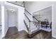 Bright foyer features hardwood floors, staircase, and dining room with chandelier, creating a welcoming entry at 12065 Watermark Ct, Indianapolis, IN 46236