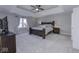 Spacious main bedroom with tray ceiling, large bed, and neutral color scheme at 12065 Watermark Ct, Indianapolis, IN 46236