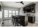 Entertainment bar area with barstools, built-in shelves, and a TV for hosting guests at 12099 Sigillary Way, Carmel, IN 46032