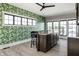 Unique bar area with granite countertop, decorative wallpaper, bar stool, and modern flooring at 12099 Sigillary Way, Carmel, IN 46032