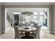 Well lit dining room and open concept living room featuring a hanging chandelier and wood floors at 12099 Sigillary Way, Carmel, IN 46032