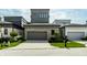 Beautiful home with a neutral color palette, manicured lawn, and lush landscaping at 12099 Sigillary Way, Carmel, IN 46032