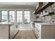 Elegant kitchen featuring white cabinetry, black-framed windows, and stainless steel appliances at 12099 Sigillary Way, Carmel, IN 46032