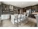 Modern kitchen featuring a large island with barstool seating, stainless steel appliances, and a brick accent wall at 12099 Sigillary Way, Carmel, IN 46032