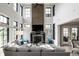 Bright living room with soaring ceilings, a fireplace, and large windows that provide natural light at 12099 Sigillary Way, Carmel, IN 46032