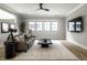 Comfortable living room with a sleek leather sofa, plush rug, and modern black coffee table at 12099 Sigillary Way, Carmel, IN 46032