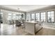 Open concept living room, dining room, and kitchen with stainless steel appliances, and hardwood floors at 12099 Sigillary Way, Carmel, IN 46032