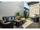 Inviting outdoor patio with comfortable seating, grill, and meticulous landscaping at 12099 Sigillary Way, Carmel, IN 46032