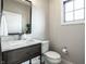 Stylish powder room with a modern vanity, elegant mirror, and contemporary fixtures at 12099 Sigillary Way, Carmel, IN 46032