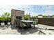 Inviting rooftop deck with an outdoor brick fireplace, dining set, and views at 12099 Sigillary Way, Carmel, IN 46032