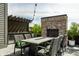 Entertaining rooftop deck boasts an outdoor kitchen, brick fireplace, and string lights at 12099 Sigillary Way, Carmel, IN 46032