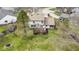 Aerial view showcasing backyard with deck, mature trees, and well-manicured lawn at 12161 Pebblebrooke Ct, Indianapolis, IN 46236