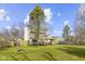 Expansive backyard featuring a deck, mature trees, green lawn, and a wooden fence at 12161 Pebblebrooke Ct, Indianapolis, IN 46236