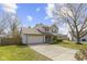 A two-story home with a well-kept lawn and features an attached garage and landscaped front yard at 12161 Pebblebrooke Ct, Indianapolis, IN 46236