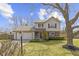 Charming two-story home featuring a well-manicured lawn, attached garage, and inviting red door at 12161 Pebblebrooke Ct, Indianapolis, IN 46236