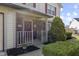 Charming front porch featuring a red door, brick accents, and decorative plants for added curb appeal at 12161 Pebblebrooke Ct, Indianapolis, IN 46236