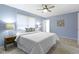Main bedroom featuring a queen bed and natural light at 12161 Pebblebrooke Ct, Indianapolis, IN 46236