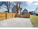 Spacious backyard features gravel area surrounded by a wooden fence for added privacy and security at 1444 English Ave, Indianapolis, IN 46201