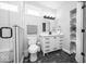 Bathroom with shower, vanity, storage shelves, and stylish geometric patterned flooring at 1444 English Ave, Indianapolis, IN 46201