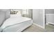 Bedroom features grey carpet and trim and a window view with a decorative painting at 1444 English Ave, Indianapolis, IN 46201