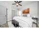 This bedroom features a ceiling fan, grey accents, and a decorative painting at 1444 English Ave, Indianapolis, IN 46201