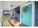 Inviting front porch showcasing a bright turquoise door and outdoor seating area at 1444 English Ave, Indianapolis, IN 46201