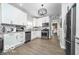 Well-lit kitchen features stainless steel appliances, white cabinetry, granite countertops, and modern lighting at 1444 English Ave, Indianapolis, IN 46201