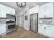 Modern kitchen featuring stainless steel appliances, white cabinetry, and stylish backsplash at 1444 English Ave, Indianapolis, IN 46201