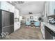 Open-concept kitchen and living room with stainless steel appliances and lots of natural light at 1444 English Ave, Indianapolis, IN 46201