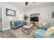 Comfortable living room with modern decor, including a sofa, patterned armchairs, and a flat-screen TV at 1444 English Ave, Indianapolis, IN 46201