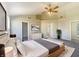 Inviting main bedroom boasts a tray ceiling, neutral décor, ceiling fan, and convenient ensuite bathroom access at 14466 Chapelwood Ln, Fishers, IN 46037