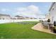 Spacious backyard with lush green grass, patio seating, and a barbecue grill at 1464 Hession Dr, Brownsburg, IN 46112