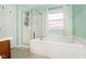 Bright bathroom featuring a shower, soaking tub with jets, and a window for natural light at 1464 Hession Dr, Brownsburg, IN 46112