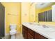 Bright bathroom with double sinks, a toilet, and shower with a curtain for privacy at 1464 Hession Dr, Brownsburg, IN 46112