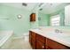 Well-lit bathroom featuring double sinks, a large mirror and coordinated hardware at 1464 Hession Dr, Brownsburg, IN 46112