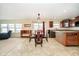Open-concept dining area connected to kitchen, with modern light fixture and ample natural light at 1464 Hession Dr, Brownsburg, IN 46112